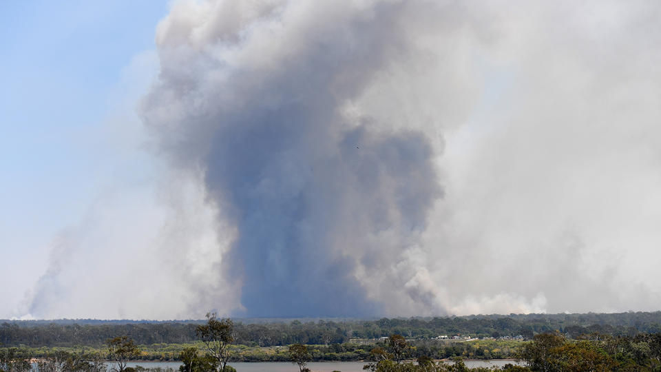 Thick smoke rises from a large bushfire near Deepwater in central Queensland on Friday. Source: AAP