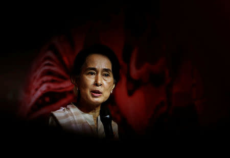 FILE PHOTO: Myanmar's opposition leader Aung San Suu Kyi speaks to the Myanmar community living in Singapore, on the island of Sentosa in Singapore September 22, 2013. REUTERS/Edgar Su/File Photo