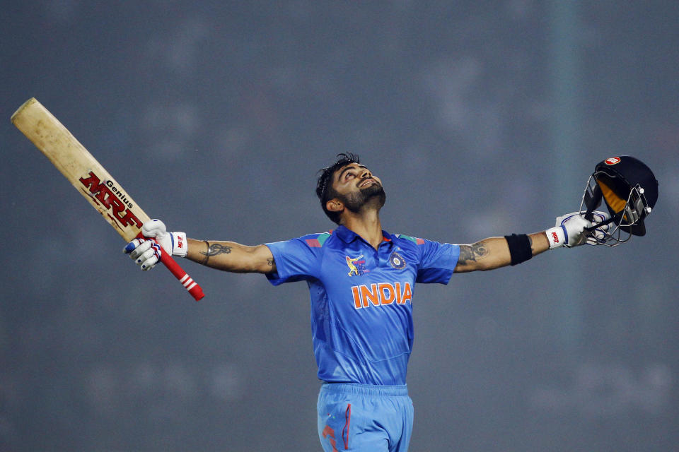 India’s Virat Kohli celebrates scoring a century during the Asia Cup one-day international cricket tournament against Bangladesh in Fatullah, near Dhaka, Bangladesh, Wednesday, Feb. 26, 2014. (AP Photo/A.M. Ahad)