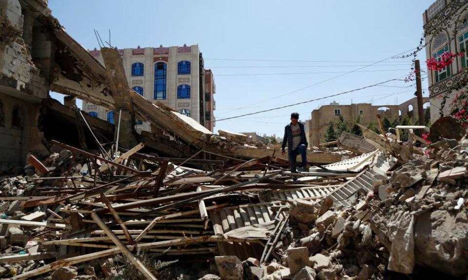 A Yemeni man inspects a house that was destroyed in an airstrike carried out during the war by the Saudi-led coalition’s warplanes, on 5 February 2021 in Sana’a.