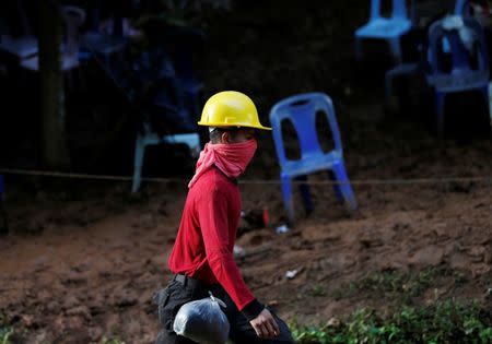 A rescue worker walks near the Tham Luang cave complex, where members of an under-16 soccer team and their coach have been found alive, in the northern province of Chiang Rai, Thailand, July 5, 2018. REUTERS/Soe Zeya Tun