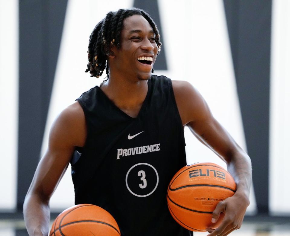 Quante Berry shares a laugh with teammates during Providence College's practice on Friday.