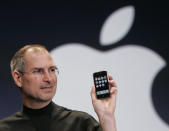 FILE - Apple CEO Steve Jobs holds up an Apple iPhone at the MacWorld Conference in San Francisco on Jan. 9, 2007. The iPhone introduced the convenience of touchscreens at the time that a physical keyboard was still all the rage on the top-selling smartphone – the BlackBerry – when Jobs first took out what was all-in-one computer, camera and music player out of his pocket in 2007. (AP Photo/Paul Sakuma, File)