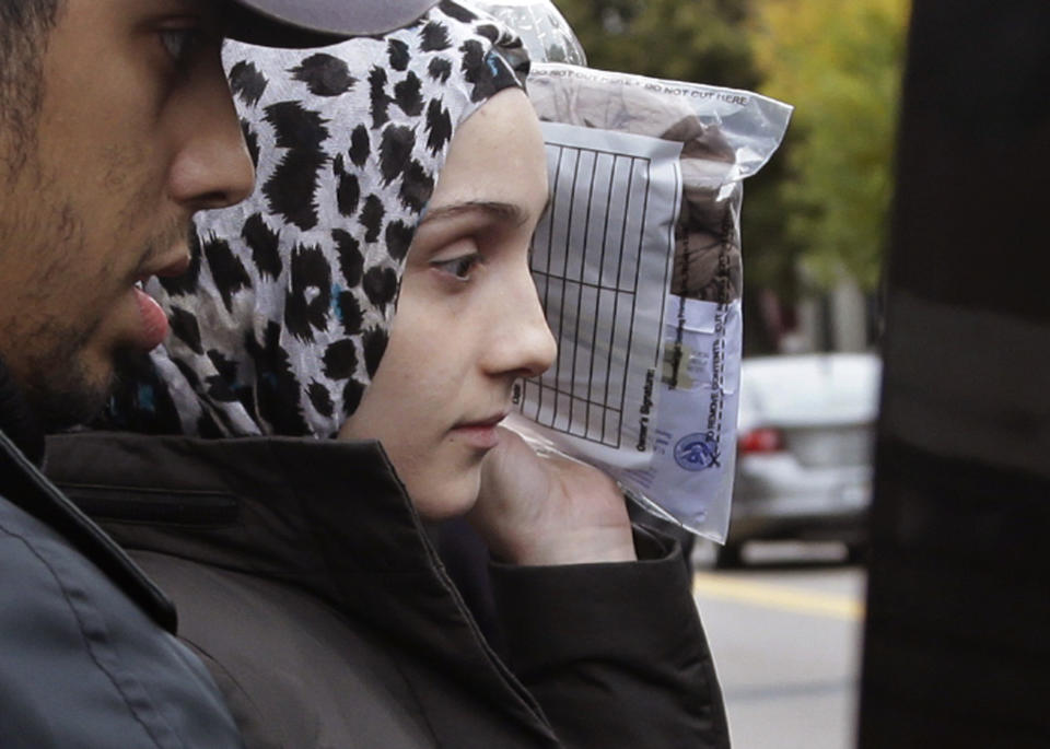 FILE- In this Oct. 13, 2014 file photo, Ailiana Tsarnaeva, sister of Boston Marathon bombing suspect Dzhokhar Tsarnaev, departs district court in Boston's South Boston neighborhood. Tsarnaeva has been arrested in New York City for allegedly threatening to bomb a Harlem woman. Police say that she is charged with aggravated harassment for threatening the woman over the phone on Monday, Aug. 25. She was issued an appearance ticket and is due back in court on Sept. 30. (AP Photo/Steven Senne, File)