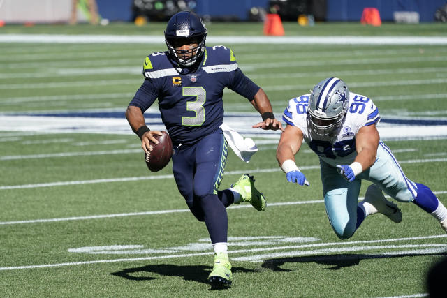 Seattle Seahawks quarterback Russell Wilson rolls out to look for an open  reciever against the Dallas Cowboys in the second half of an NFL football  game, Sunday, Sept. 16, 2012, in Seattle. (