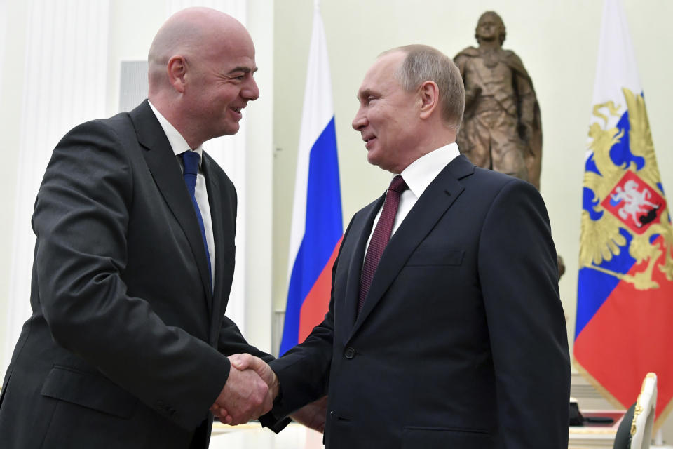 Russian President Vladimir Putin, right, and FIFA President Gianni Infantino greet each other during a meeting in the Kremlin in Moscow, Russia, Wednesday, Feb. 20, 2019. (Yuri Kadobnov/Pool Photo via AP)