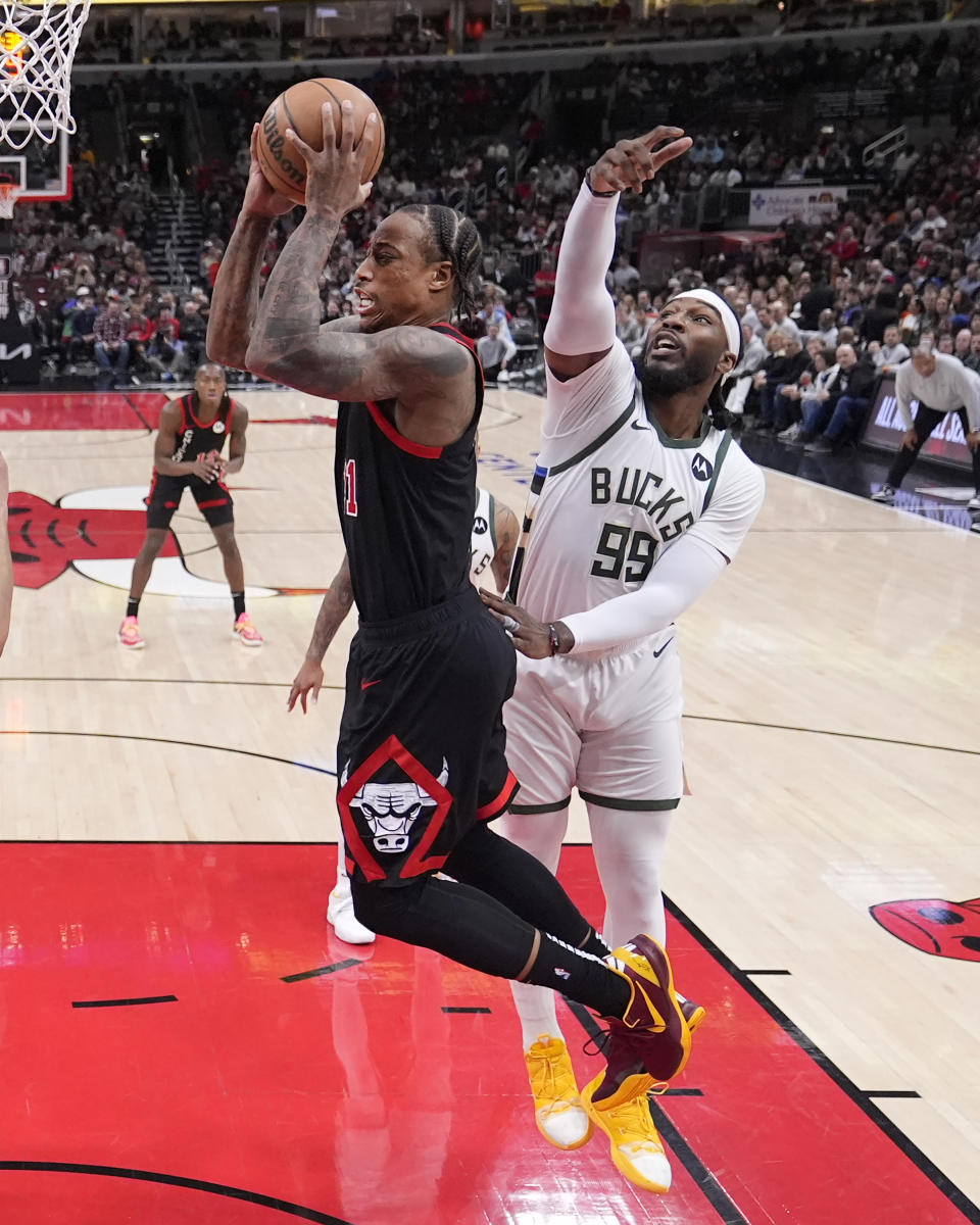 Chicago Bulls' DeMar DeRozan drives to the basket past Milwaukee Bucks' Jae Crowder during the first half of an NBA basketball game Friday, March 1, 2024, in Chicago. (AP Photo/Charles Rex Arbogast)