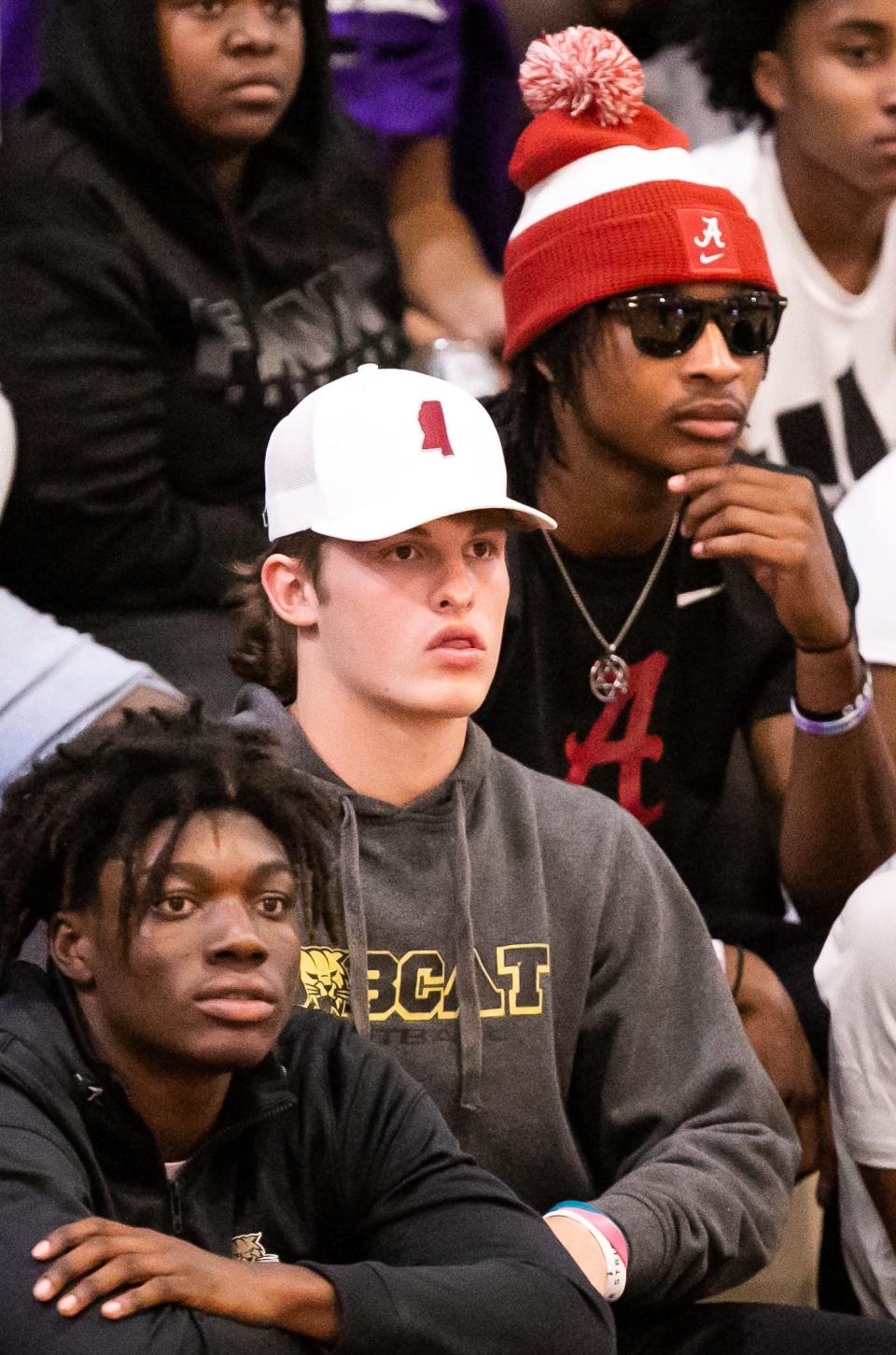 Buchholz Quarterback Creed Whittemore wears a Mississippi State hat, left, while sitting next to fellow teammate wide receiver Jaren Hamilton, right, wearing an Alabama beanie while watching the Gainesville Hurricanes hosting the P.K. Yonge Blue Wave at Gainesville High School in Gainesville, FL on Tuesday, November 29, 2022. Whittemore recently committed to Mississippi State while Hamilton recently committed to Alabama. The Hurricanes won 57-54. [Doug Engle/Ocala Star Banner]