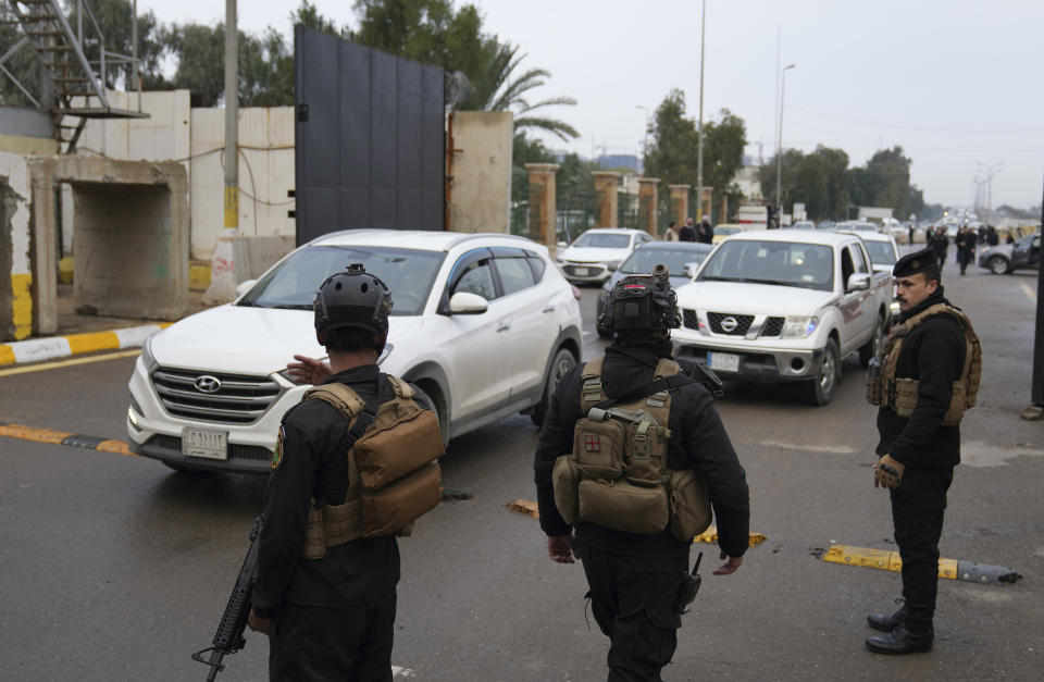 Iraqi security forces stand guard as they check motorists entering the Green Zone, in Baghdad, Iraq, Sunday, Jan. 8, 2023. (AP Photo/Hadi Mizban)