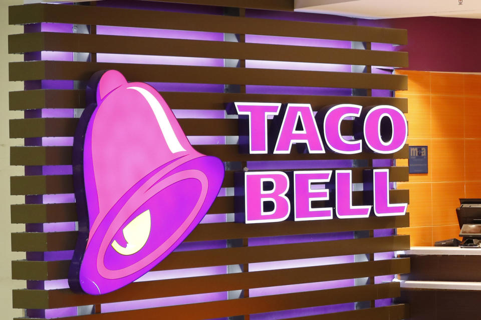 FILE - The Taco Bell logo is seen, April 19, 2019, at a restaurant in Miami. Food ads have long made their subjects look bigger, juicier and crispier than they are in person. But some consumers say those mouthwatering ads can cross the line into deception, and that’s leading to a growing number of lawsuits. Burger King is the latest company in the crosshairs. While the case against Burger King was filed in Miami, one of the attorneys who filed it has similar cases pending in New York against Wendy’s, McDonald’s and Taco Bell. (AP Photo/Wilfredo Lee, File)