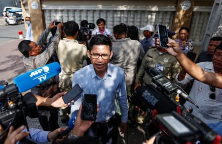 Yeang Sothearin and Uon Chhin, former journalists from the U.S.-funded Radio Free Asia (RFA), who have been charged with espionage, speak to the media in front of the Municipal Court of Phnom Penh after receiving their verdict, in Phnom Penh