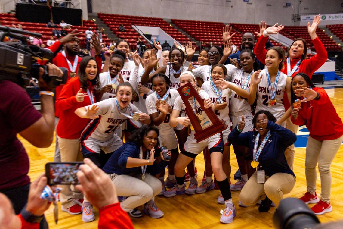 Miami Country Day players react with the first place trophy after defeating Cardinal Mooney 54-38 during the Class 3A state Girls’ basketball championship game at RP Funding Center in Lakeland, Florida, on Saturday, February 25, 2023.