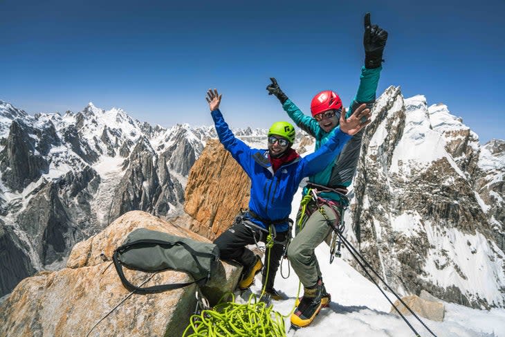 Climbers pose and smile on the summit of Nameless Tower. 