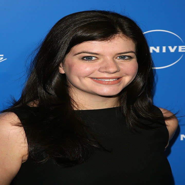 Close-up of Casey smiling and wearing a sleeveless outfit