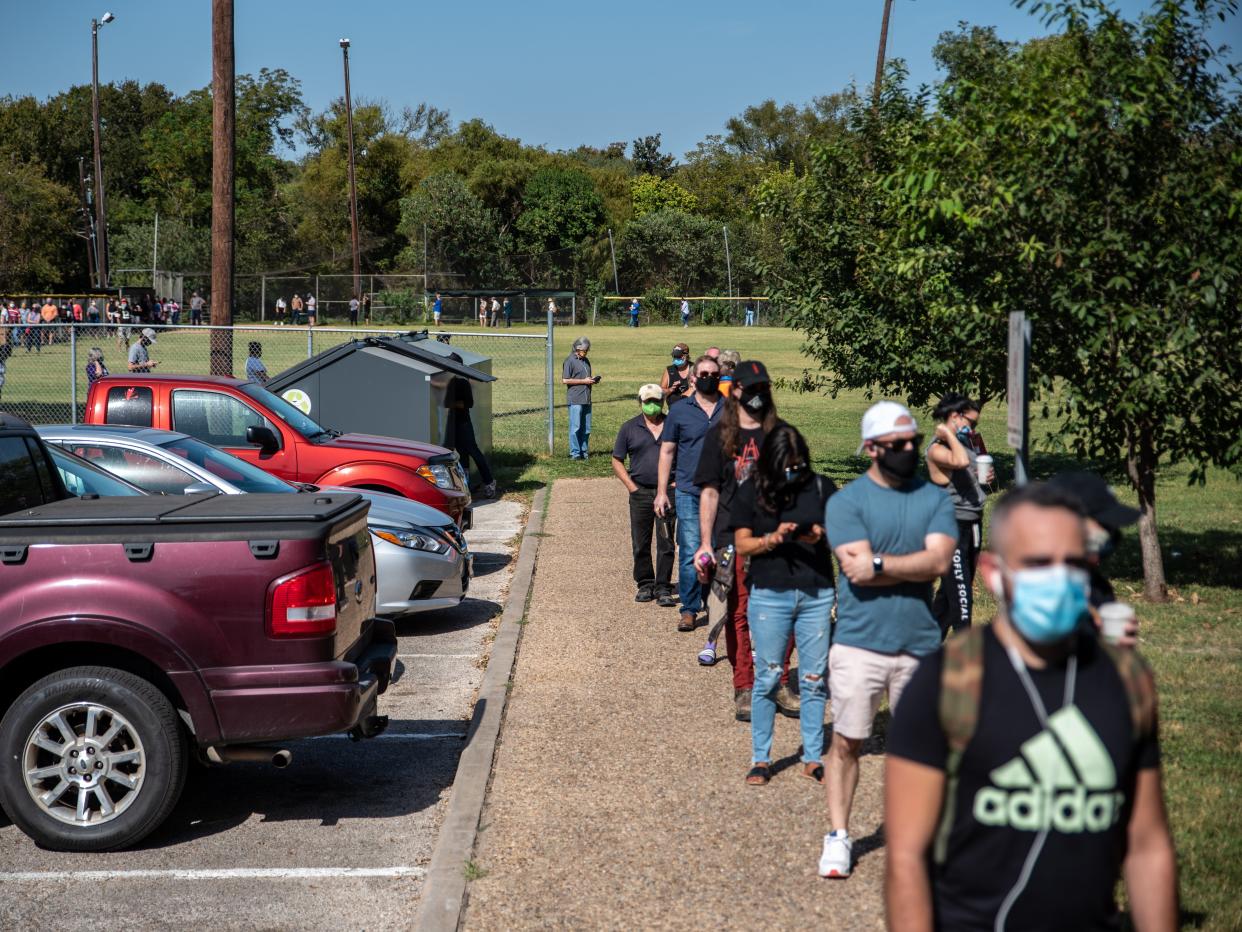 Early voters wait in line at a polling location on 13 October in Austin, Texas (Getty)