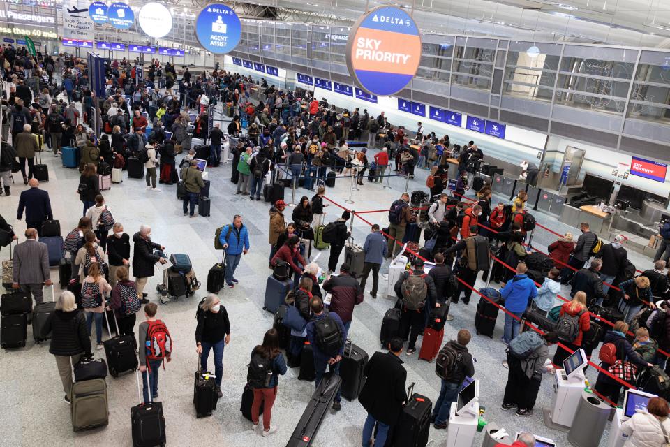 Travelers wait in line to check-in for their flights at Terminal 1 ahead of the Christmas Holiday at Minneapolis-St Paul Airport on Thursday (www.keremyucel.com)