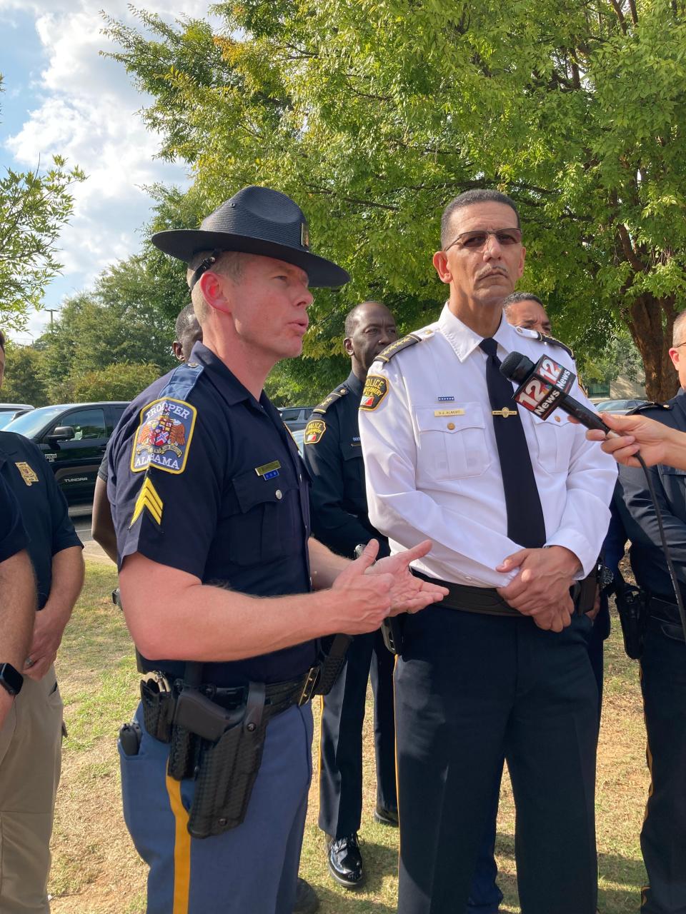 Sgt. Jeremy Burkett, with the Alabama Law Enforcement Agency, discusses the pursuit of a suspect, while Chief Darryl Albert looks on.