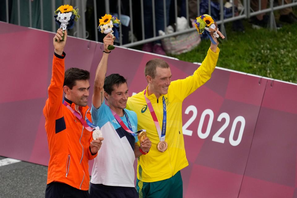 Tom Dumoulin, left, stands on the podium in the Men's Individual Time Trial.