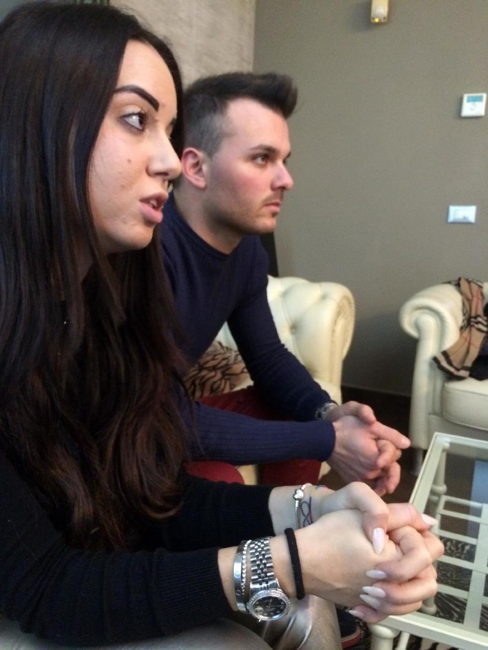 Vincenzo Forti, right, and Giorgia Galassi, left, two of the nine survivors of the avalanche that hit the Hotel Rigopiano last Wednesday, talk to the Associated Press in Giulianova, Italy, Wednesday, Jan. 25, 2017. In an interview with The Associated Press at her parents' home, Giorgia Galassi says she never imagined that an avalanche could have been responsible for the devastation around her in the Hotel Rigopiano. (AP Photo/Nick Dumitrache)
