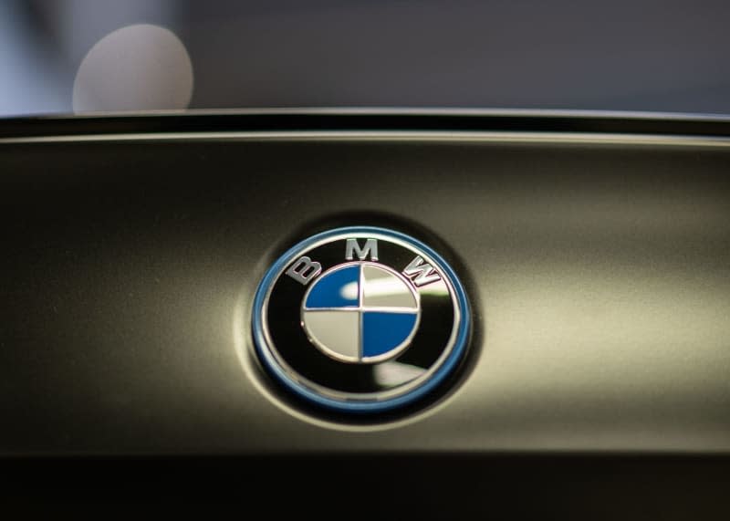The BMW logo can be seen on the trunk lid of a car at the Dresden branch. Robert Michael/dpa