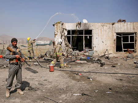 An Afghan policeman keeps watch at the site of a blast in Kabul, Afghanistan March 17, 2018. REUTERS/Mohammad Ismail