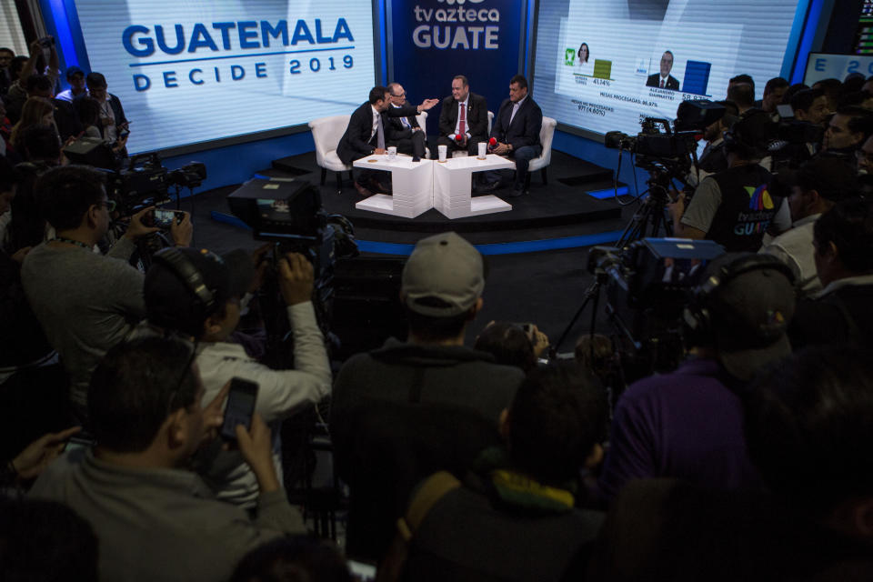 Alejandro Giammatei, presidential candidate of the Vamos party, gives an interview at the Electoral Supreme Court headquarters after partial election results were announced in Guatemala City, Sunday, Aug. 11, 2019. Giammattei headed for a victory in Sunday’s presidential runoff election, garnering favor with voters for his get-tough approach on crime and socially conservative values. (AP Photo/Oliver de Ros)