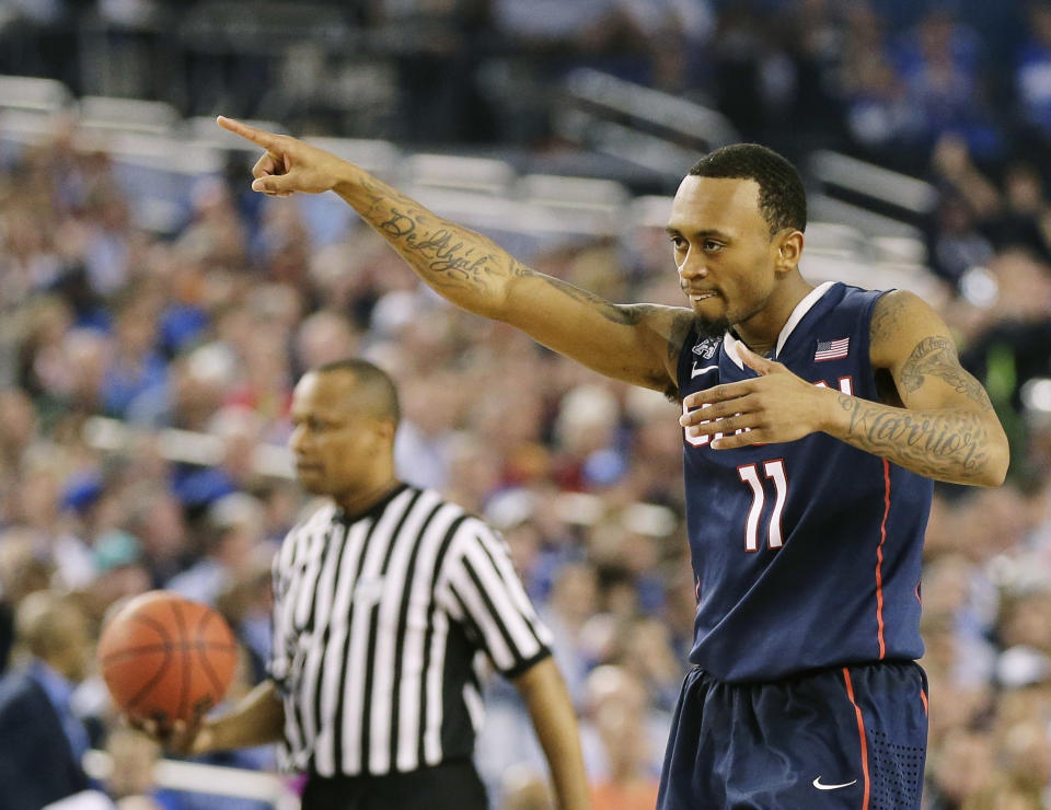 Connecticut guard Ryan Boatright (11) celebrates as he walks down court against Florida during the second half of the NCAA Final Four tournament college basketball semifinal game Saturday, April 5, 2014, in Arlington, Texas. (AP Photo/Eric Gay)