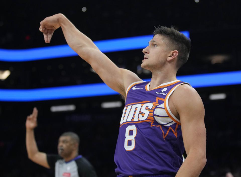 Suns guard Grayson Allen (8) shoots a three pointer against the Hawks during a game at the Footprint Center.