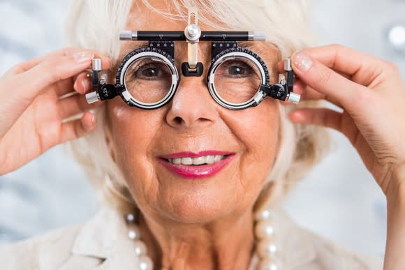 A senior woman getting her eyes checked.