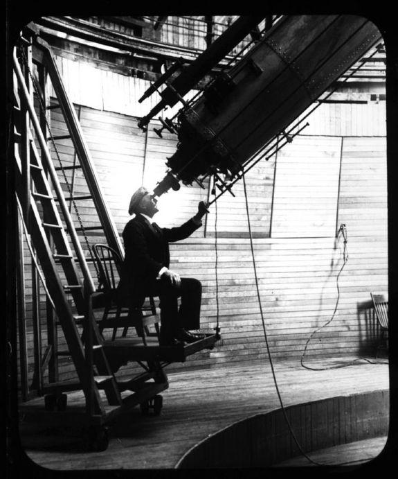 In a historical photo, Percival Lowell looks through the Clark telescope at Lowell Observatory, Flagstaff, Arizona. File photo undated.