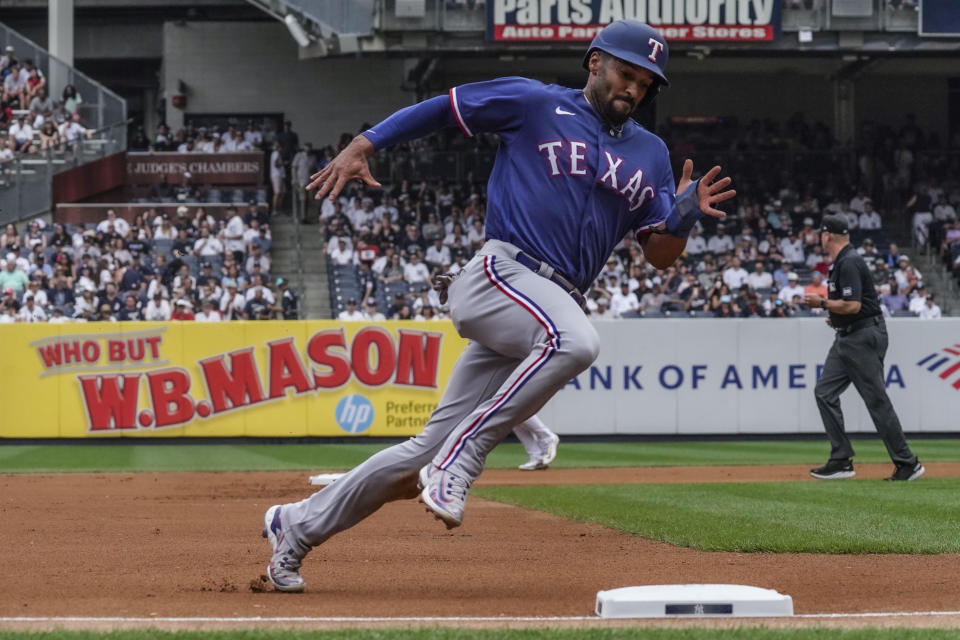 Texas Rangers' Marcus Semien races around third base on his way to score a run in the first inning of a baseball game against the New York Yankees, Sunday, June 25, 2023, in New York. (AP Photo/Bebeto Matthews)
