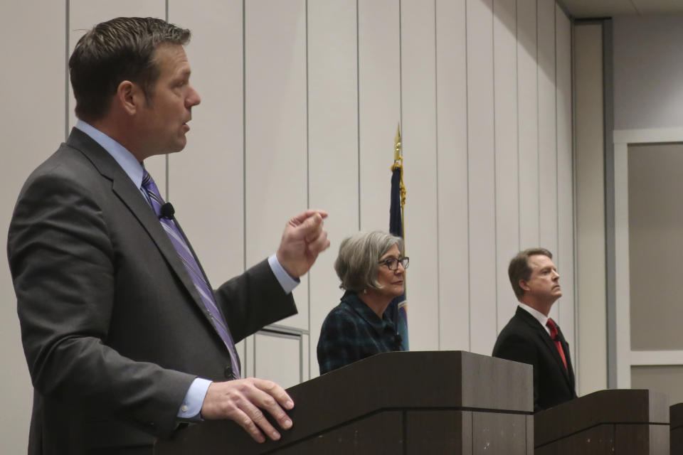 Former Kansas Secretary of State Kris Kobach, left, a Republican candidate, speaks during a debate for GOP candidates at a statewide Republican convention, Saturday, Feb. 1, 2020, in Olathe, Kan. Also participating are Kansas Senate President Susan Wagle, center, of Wichita, and U.S. Rep. Roger Marshall, of western Kansas. (AP Photo/John Hanna)