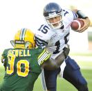 left to right - Edmonton Eskimos player # 90 ( DL) Almondo Sewell goes for the sack on Toronto Argonauts player # 15 (QB ) Ricky Ray during the 4th quarter of CFL game action between the Edmonton Eskimo's and the Toronto Argonauts at Commonwealth stadium in Edmonton June 30/2012 (CFL PHOTO / Walter Tychnowicz)