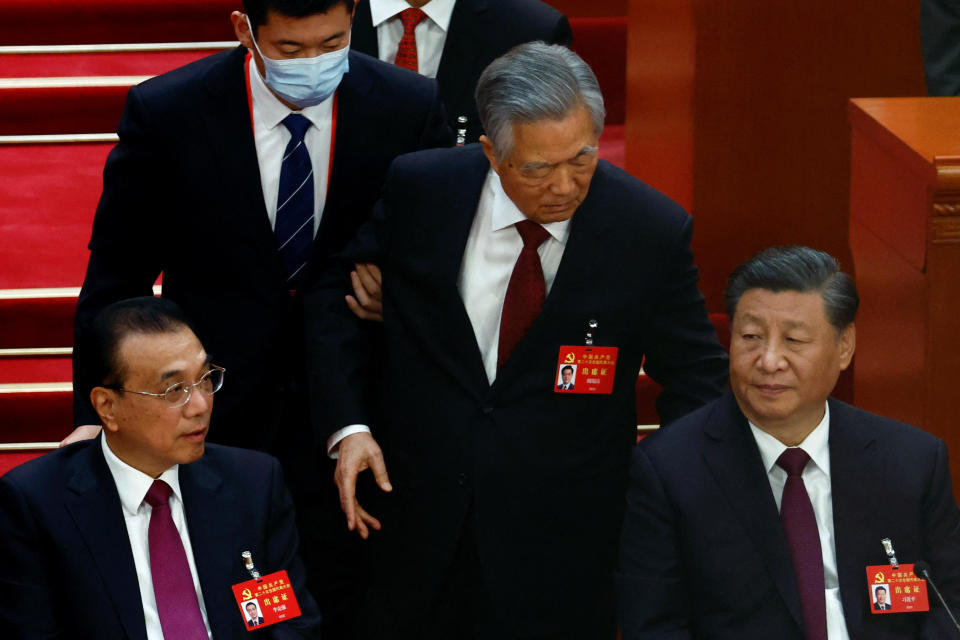 Former Chinese President Hu Jintao leaves his seat next to Chinese President Xi Jinping and Premier Li Keqiang during the closing ceremony of the 20th National Congress of the Communist Party of China at the Great Hall of the People in Beijing, China, Oct. 22, 2022. / Credit: Reuters/Tingshu Wang