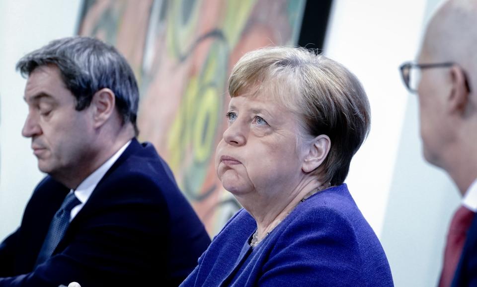 (L-R) Markus Soeder, Bavaria's State Premier, German Chancellor Angela Merkel and Peter Tschentscher, Mayor of Hamburg attend a press conference at the Chancellery in Berlin on April 30, 2020 after holding a telephone conference with the leaders of the Federal states on the restrictions during the novel coronavirus COVID-19 pandemic. (Photo by Kay Nietfeld / various sources / AFP) (Photo by KAY NIETFELD/POOL/AFP via Getty Images)