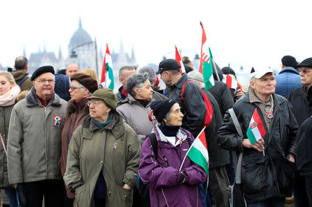 People attend Hungarian march at a pro-Orban rally during Hungary's National Day celebrations, which also commemorates the 1848 Hungarian Revolution against the Habsburg monarchy, in Budapest, Hungary March 15, 2018. Picture taken March 15, 2018. REUTERS/Bernadett Szabo