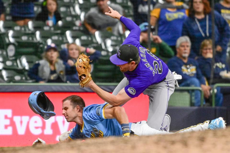 Brewers pinch runner Brewer Hicklen is tagged out by Rockies third baseman Ryan McMahon trying to advance on a fly ball for the final out of the game Friday night at American Family Field.