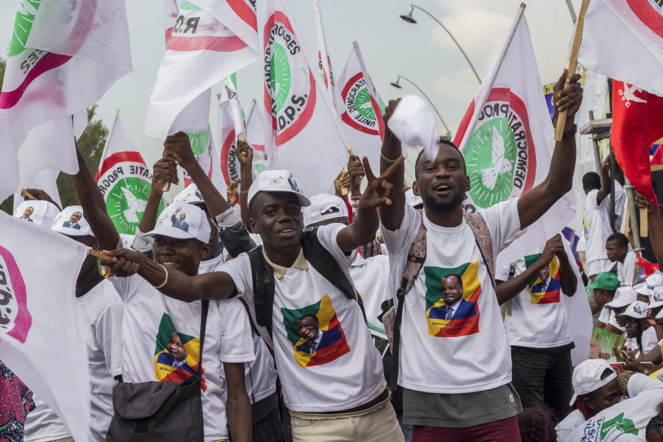 Supporters of President Denis Sassou N'Guesso cheer during the last rally of the presidential campaign in Brazzaville, Congo, Friday March 19, 2021. After 36 years in power, Republic of Congo's President Denis Sassou N’Guesso appears poised to extend his tenure as one of Africa's longest-serving leaders in the elections to be held Sunday amid opposition complaints of interference with their campaigns. (AP Photo/Zed Lebon)