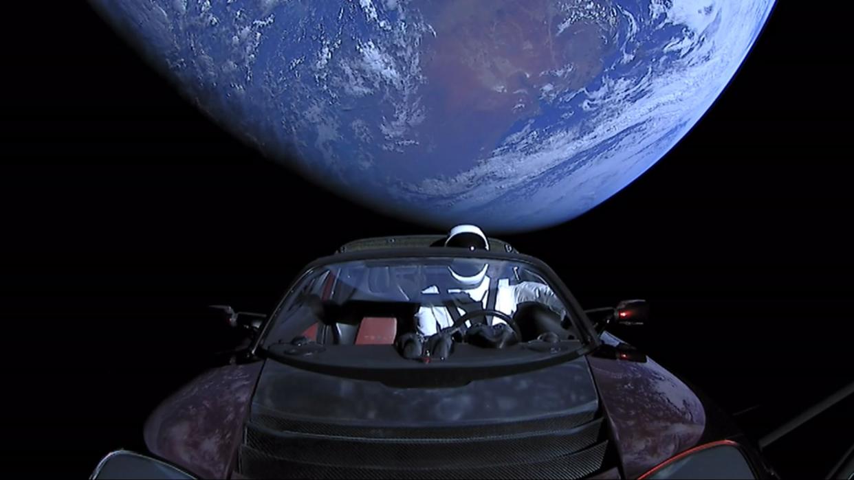 A Tesla Roadster in space with dummy driver named Starman.
