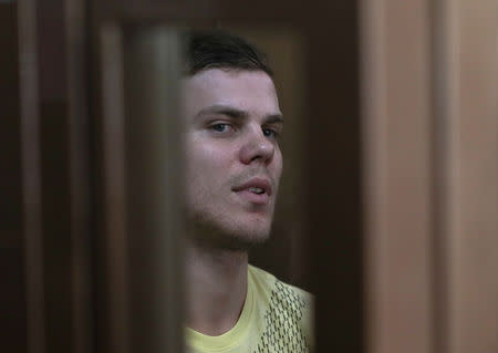 Russian soccer player Alexander Kokorin, who is charged with a brutal assault and held in custody, is seen inside a defendants' cage as he attends a court hearing in Moscow, Russia May 6, 2019. REUTERS/Evgenia Novozhenina