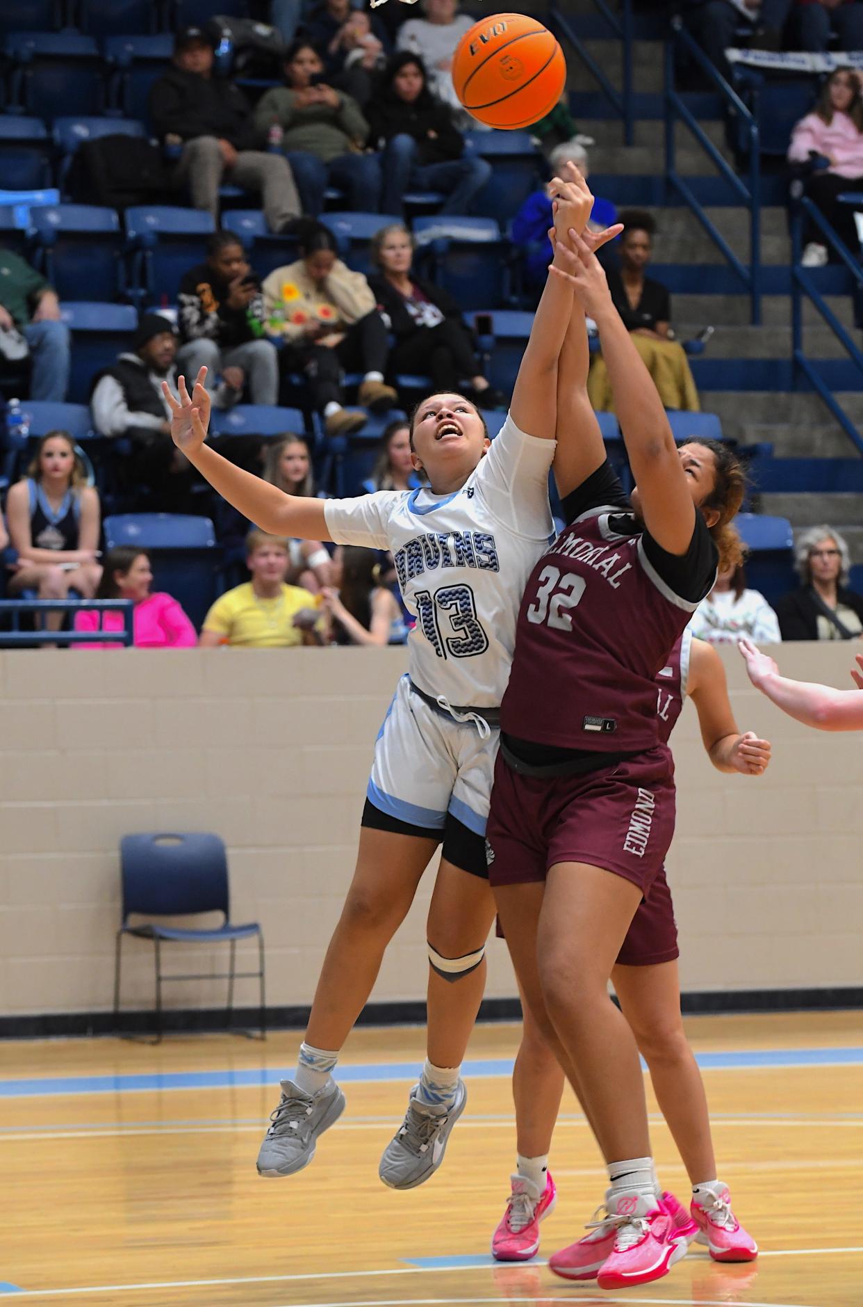 Bartlesville High School's Mikka Chambers (13) goes up for a rebound during basketball action earlier in the season.
