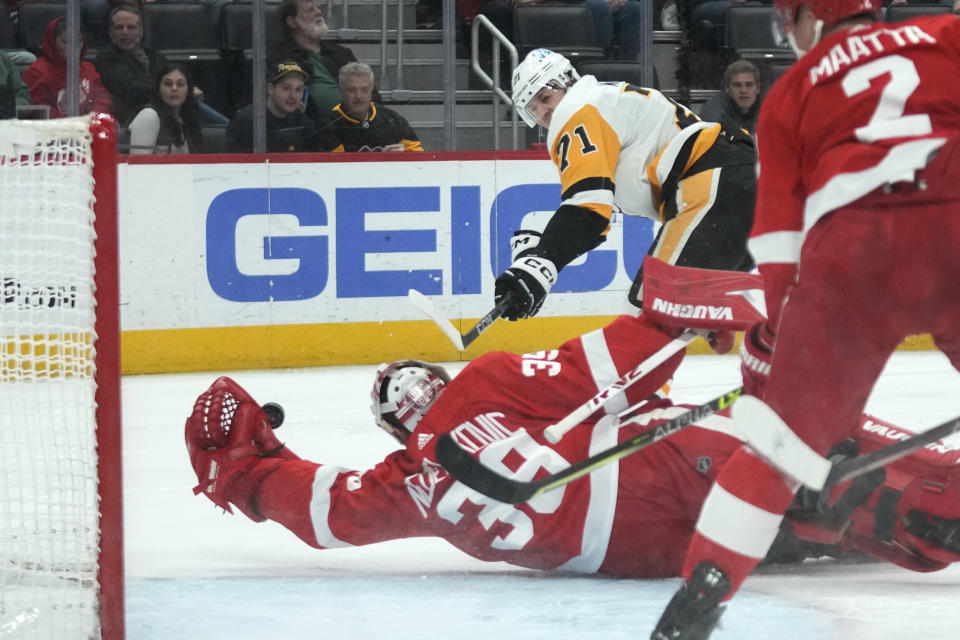 Detroit Red Wings goaltender Alex Nedeljkovic (39) stops a Pittsburgh Penguins center Evgeni Malkin (71) shot in the first period of an NHL hockey game Tuesday, March 28, 2023, in Detroit. (AP Photo/Paul Sancya)