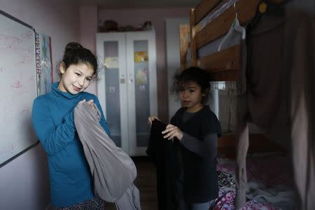 Sanaa, 10, and her sister Israa, 7, get ready for Islamic Saturday school in Leyton, east London November 9, 2013. REUTERS/Olivia Harris