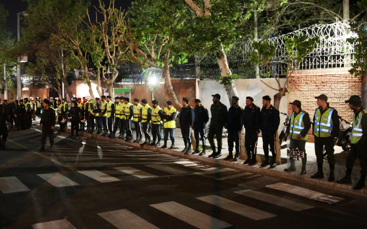 Police take security measures as people holding Iranian flags gather to stage a demonstration in support of Iran's attack on Israel in Tehran