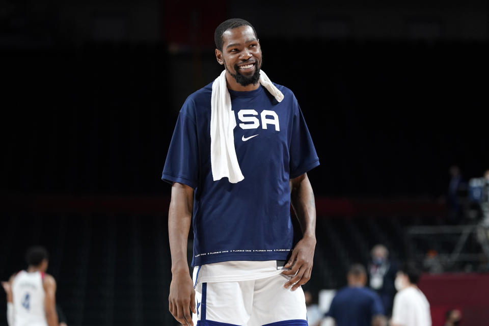 United States's Kevin Durant smiles as he walks off the court at the end of a men's basketball preliminary round game against the Czech Republic at the 2020 Summer Olympics, Saturday, July 31, 2021, in Saitama, Japan. (AP Photo/Charlie Neibergall)