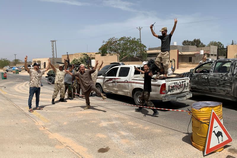 Fighters loyal to Libya's internationally recognised government celebrate after regaining control over Tripoli