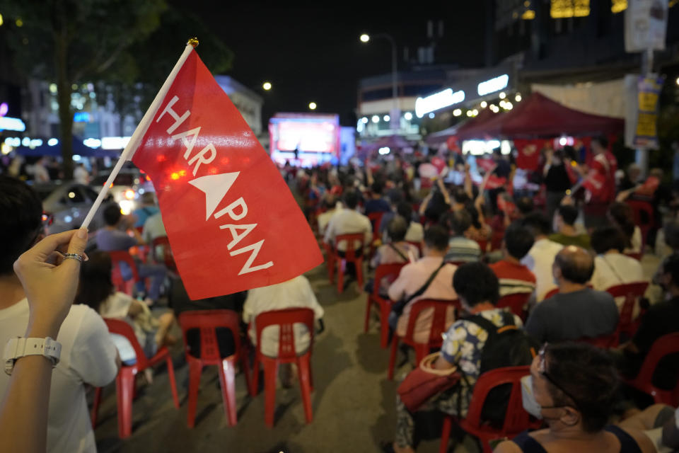 A Pakatan Harapan (Alliance of Hope) coalition supporter waves a flag during an election rally in Kuala Lumpur, Malaysia, Wednesday, Nov. 16, 2022. Malaysia's general elections will take place Saturday, over a month after Prime Minister Ismail Sabri Yaakob dissolved Parliament and announced snap elections. The country's longest-serving coalition is seeking to regain its dominance after a shocking loss in 2018, but political reformers are aiming for a second surprise win. (AP Photo/Vincent Thian)