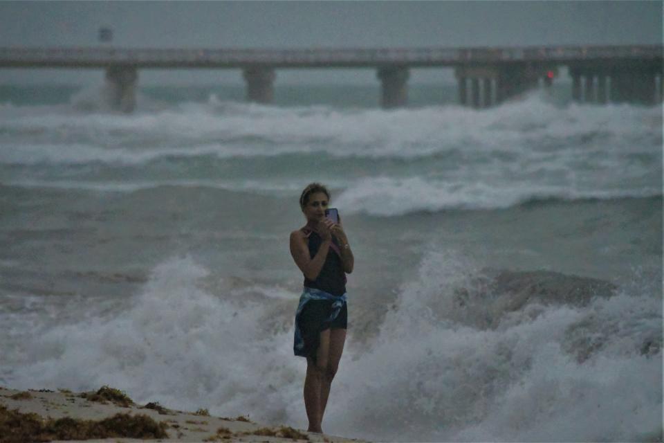 A woman grabs a selfie to remember then Hurricane Isaias near Miami. Photo by Paul Scicchitano.