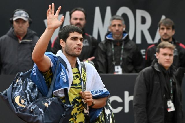 Carlos Alcaraz waves as he leaves the court in Rome after a defeat just two weeks before the French Open where he will be top seed
