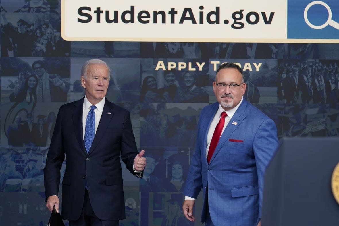 President Joe Biden answers questions with Education Secretary Miguel Cardona as they leave an event about the student debt relief portal beta test in the South Court Auditorium on the White House complex in Washington, Oct. 17, 2022. (AP Photo/Susan Walsh, File)